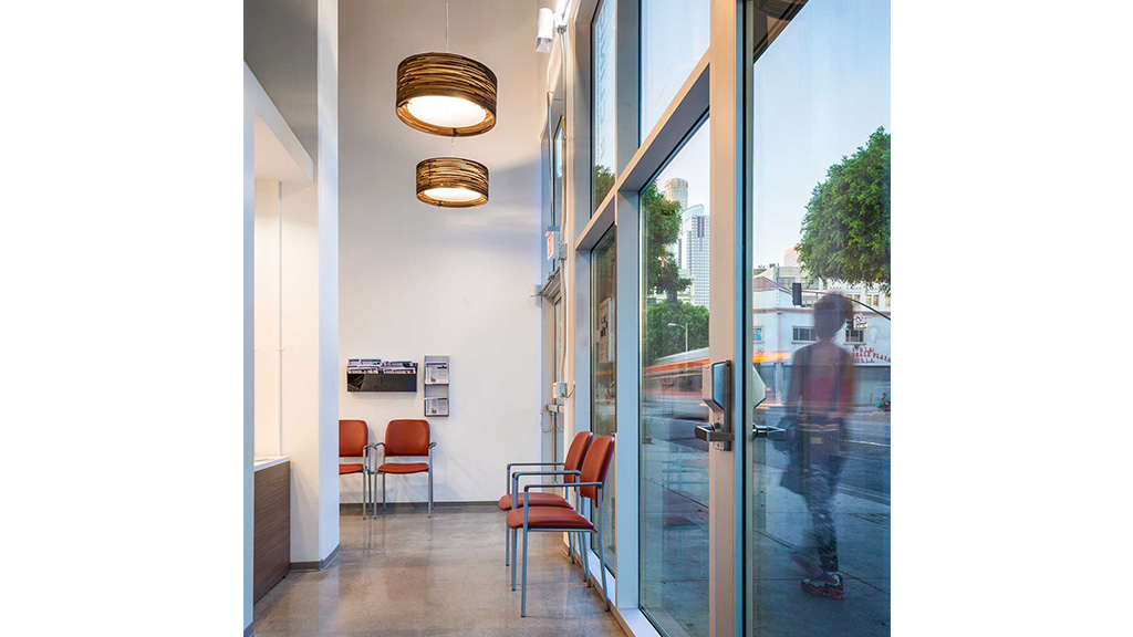 A hallway with chairs and a light.