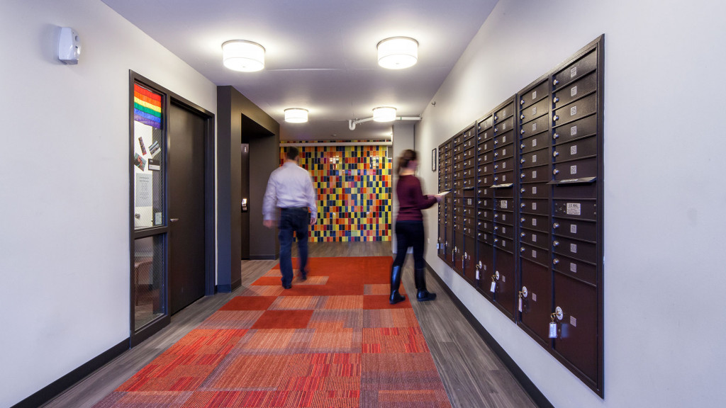 A man and woman walking through a hallway.
