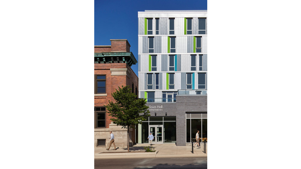 A building with a few people walking around.