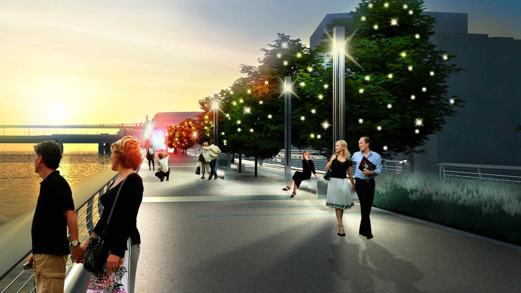A group of people walking on a street with trees and lights.