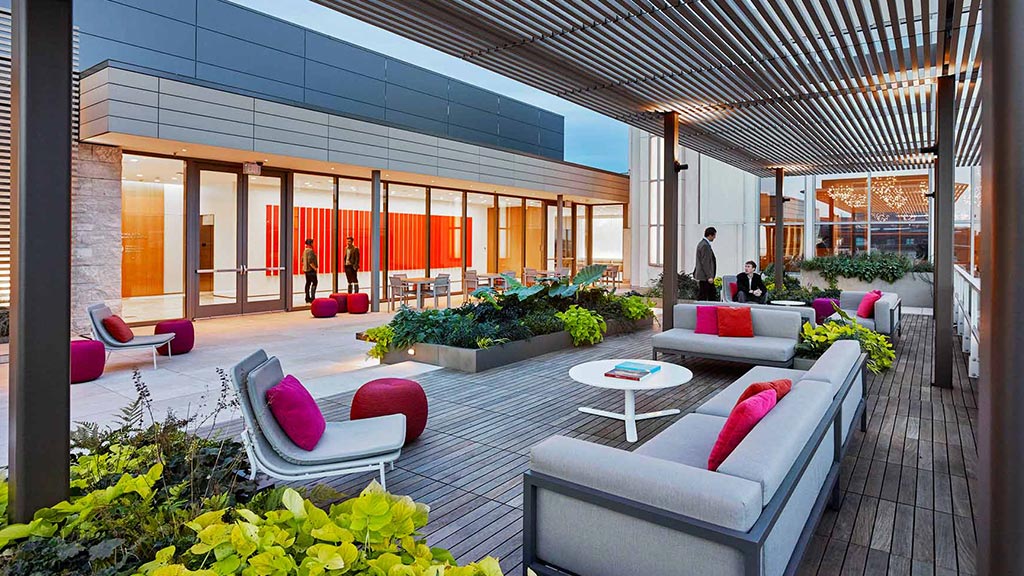 A patio with a couch and chairs.