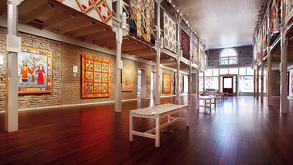 A large room with paintings on the walls.