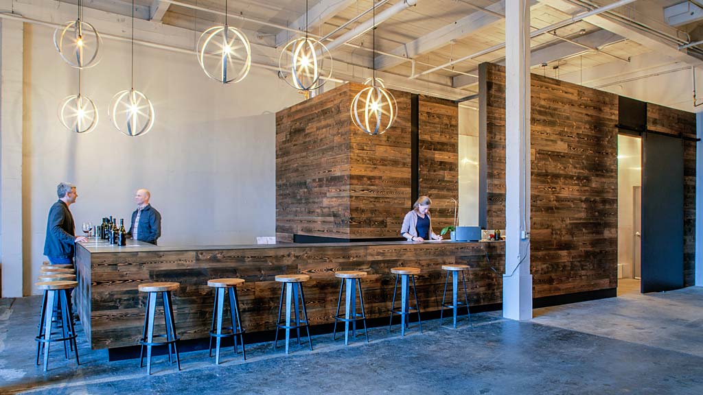 A group of people sitting at a bar.