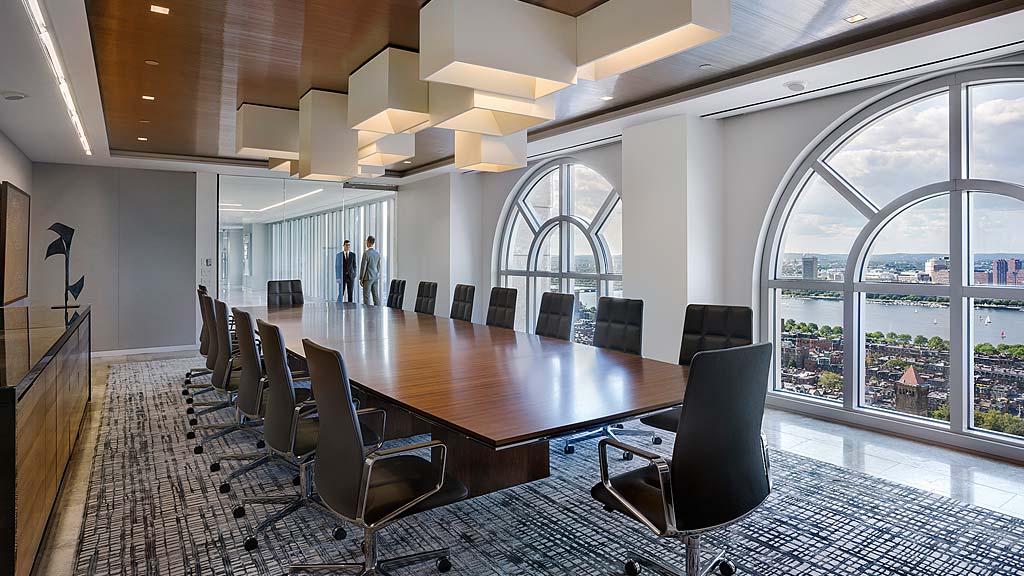 A large conference room with a large table and chairs.