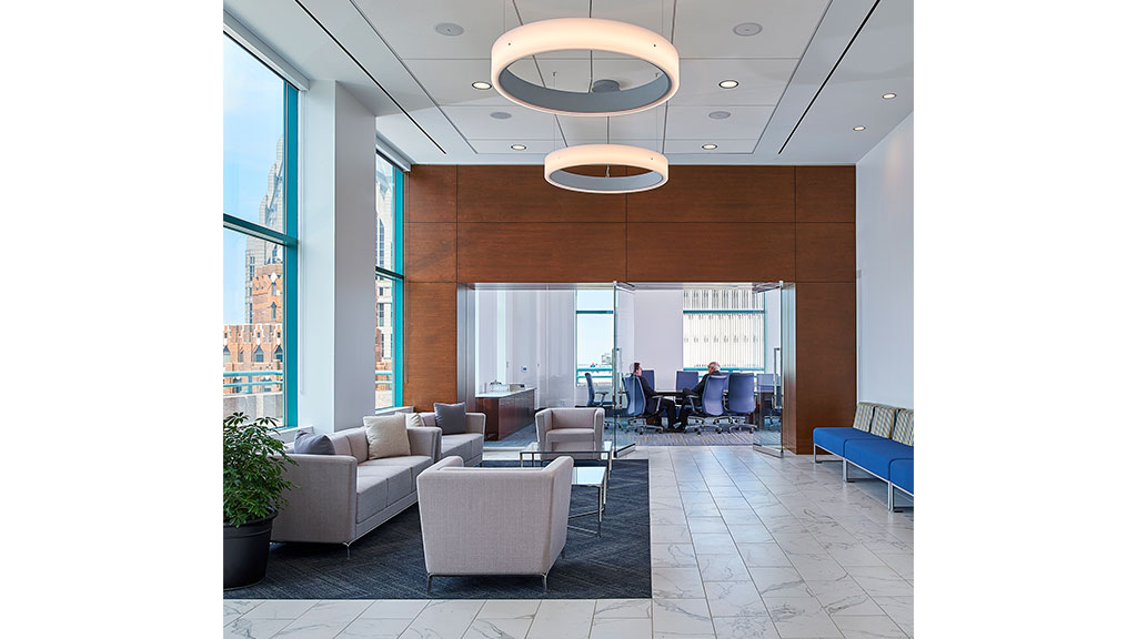 A room with a large glass window and a large chandelier.