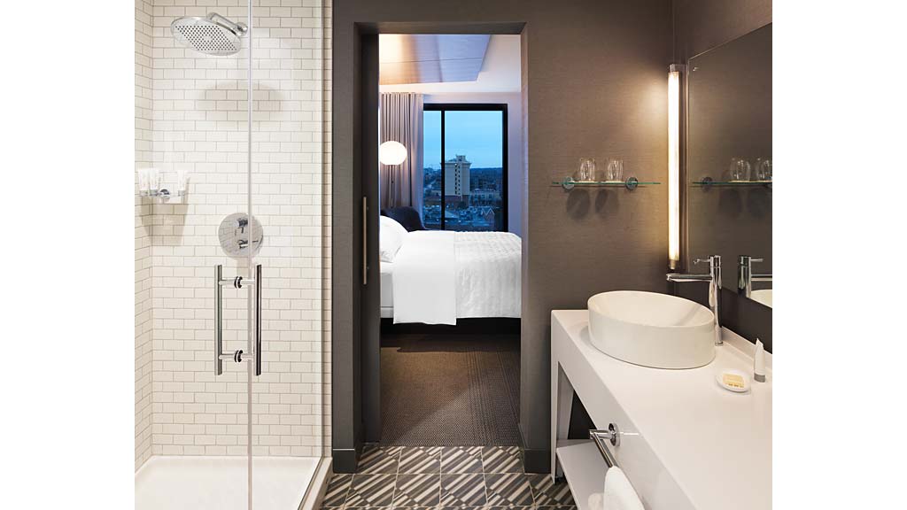 A bathroom with a tub sink and toilet.