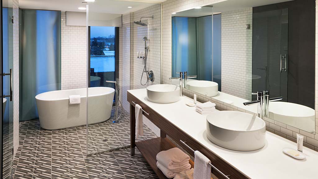 A bathroom with a tub sink and a bathtub.