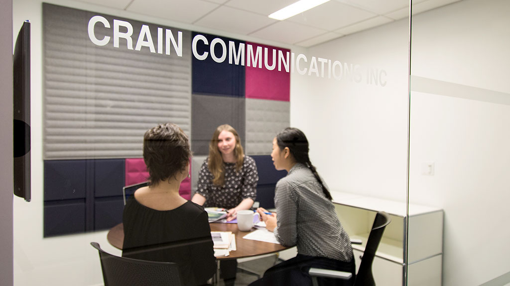 A group of people sitting around a table.