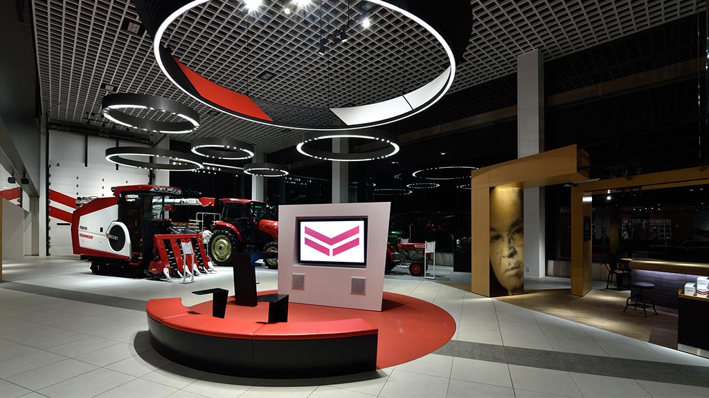 A large room with a large display and a large red machine.