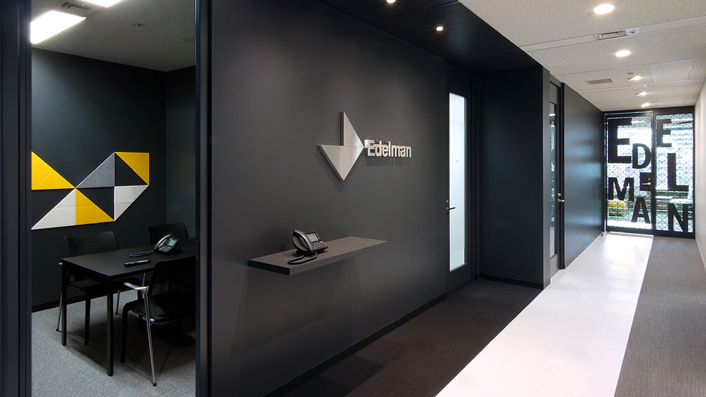 A modern office with a desk and chairs.