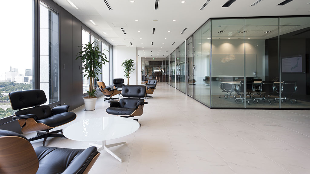 A room with a glass wall and chairs.