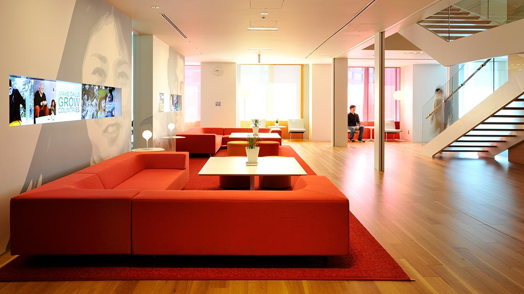 A large room with a red couch.