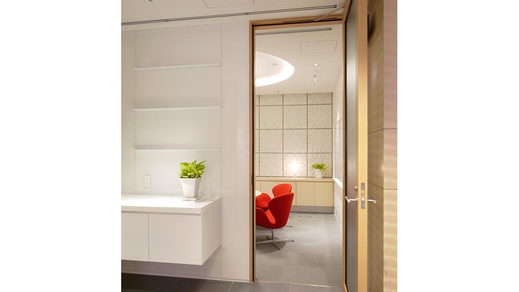 A chair and a desk in a room with a tile floor.