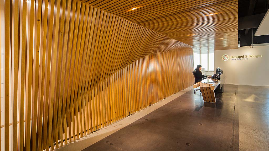 A couple of people sitting on a bench in a large room.