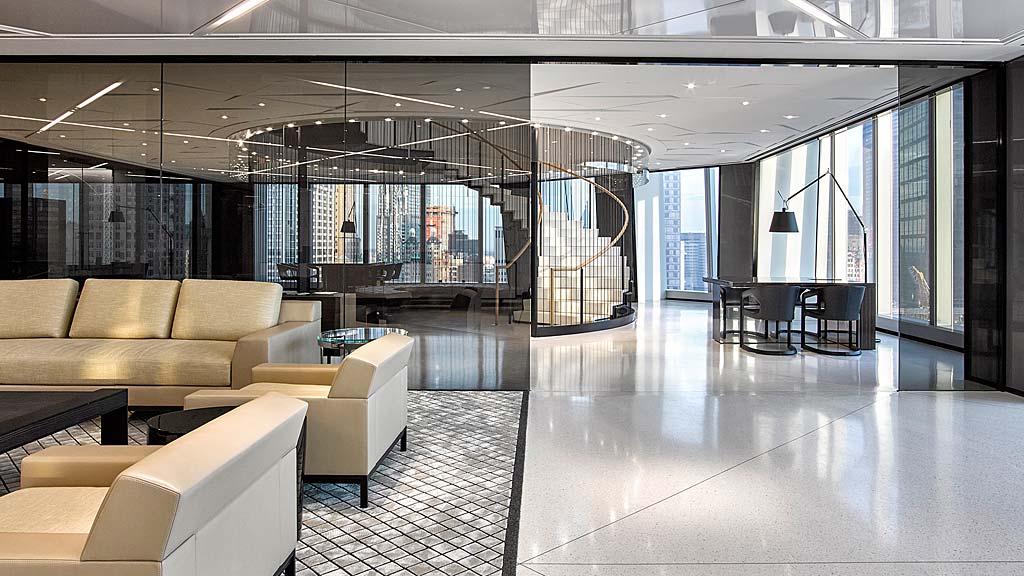 A large room with a large glass wall and a large white floor.