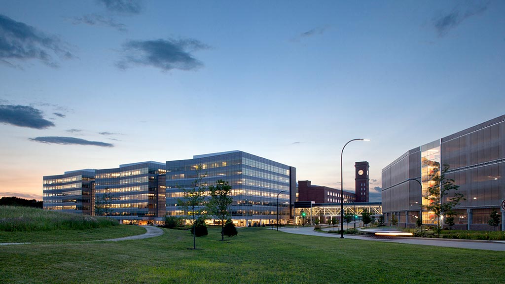 A large building with a green lawn.