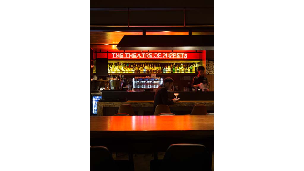 A couple of men sitting at a bar.