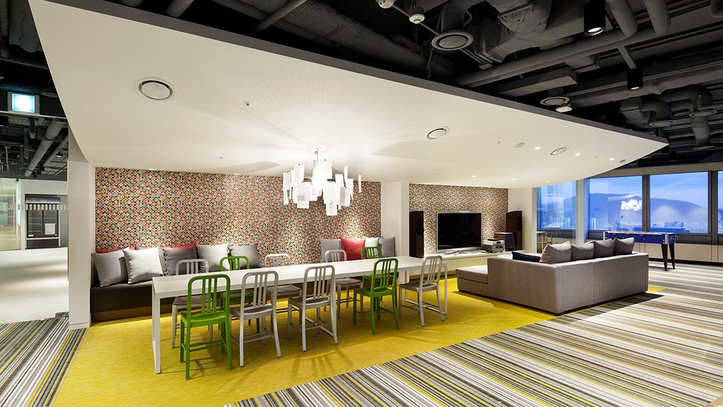 A room with a couch and chairs.