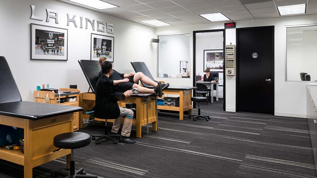 A man and woman sitting at desks in an office.