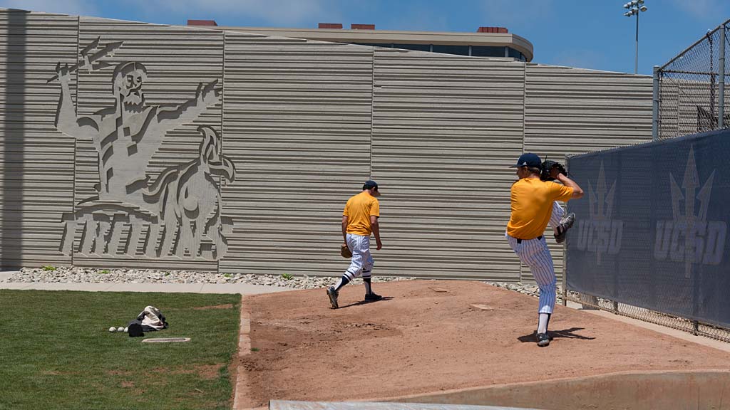 A baseball player prepares to swing a bat.