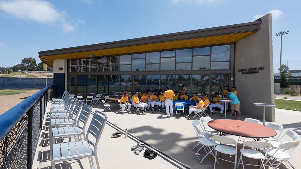 A group of people sitting outside a building.