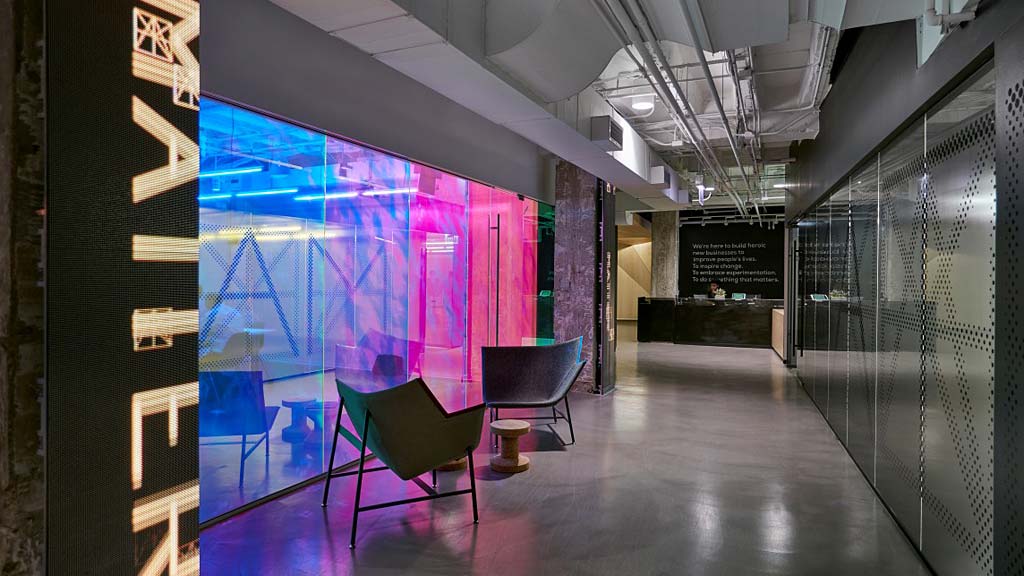 A room with a wall of posters.