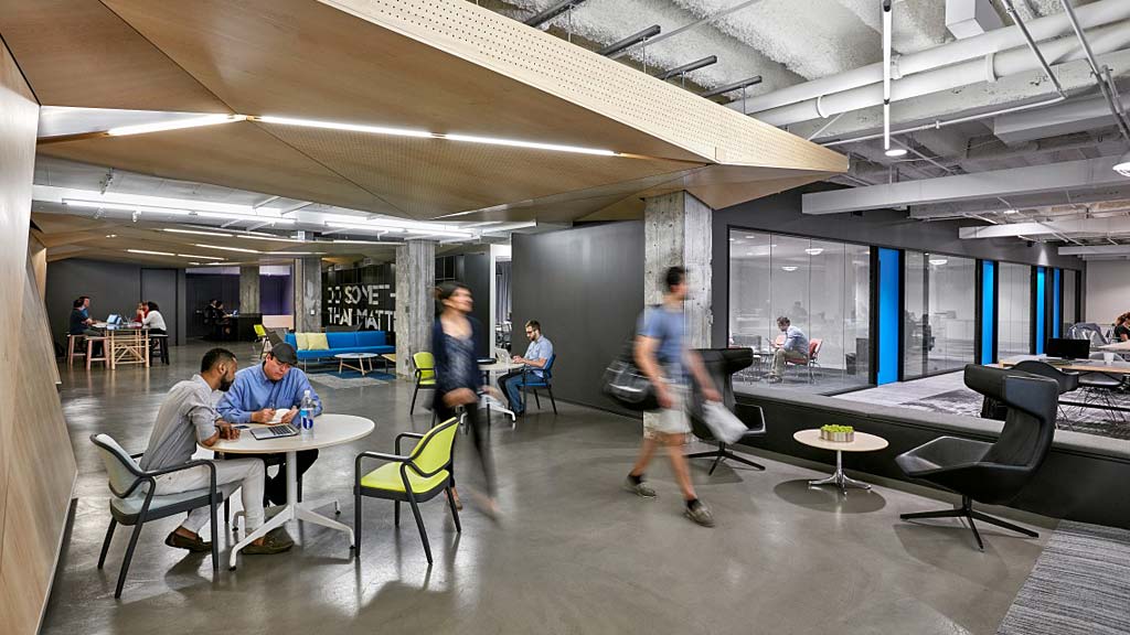 People in a room with tables and chairs.