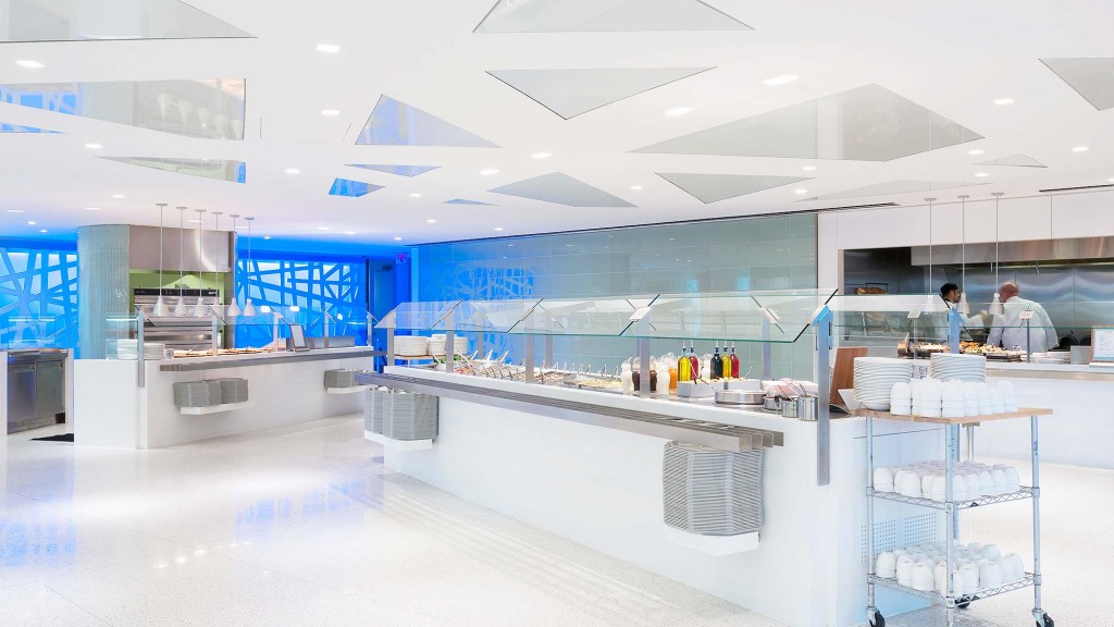 A large room with a few people.