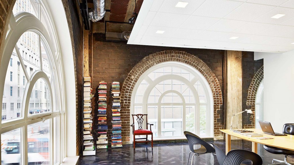 A room with a table chairs and a staircase.