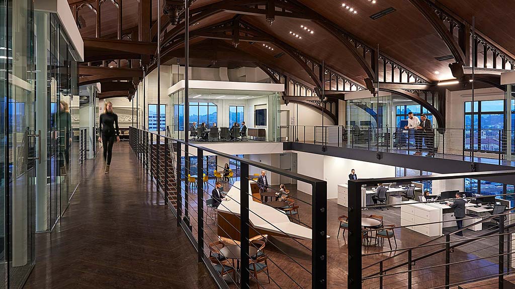 A large room with people and a large glass wall.