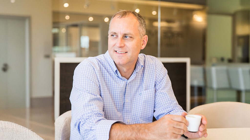 A man holding a cup.