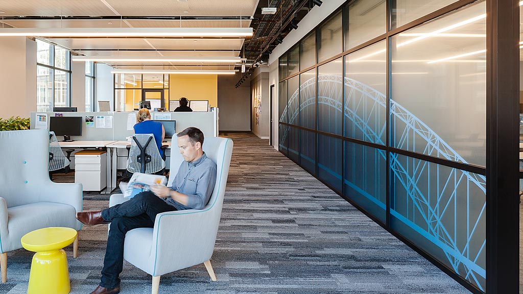 A few people sitting in an office.