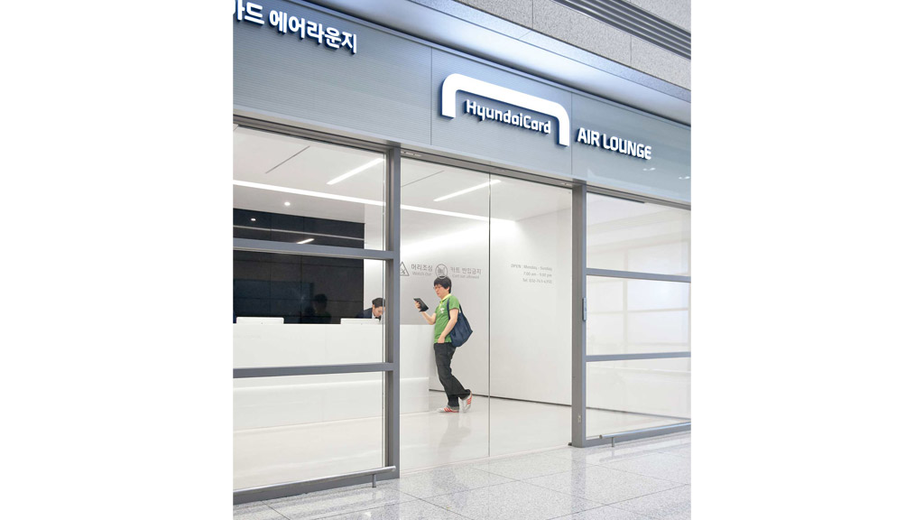A man standing in front of a glass door.