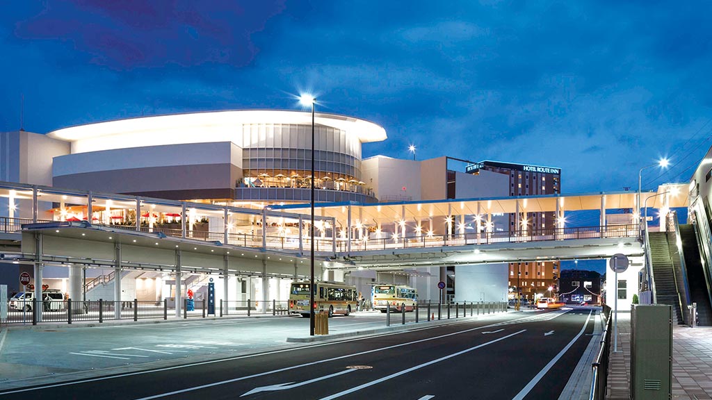 A large building with a parking lot.