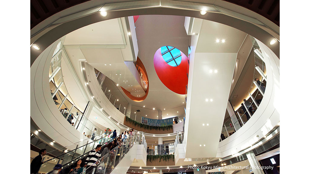 A large white building with a large red balloon in the middle.