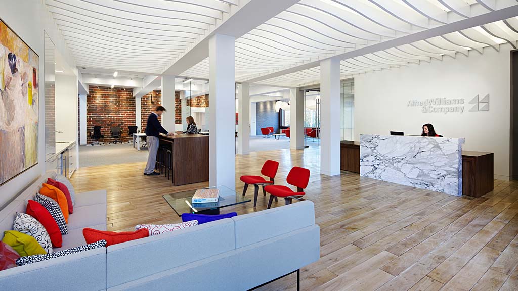 A room with a wood floor and a wood floor with a white ceiling.