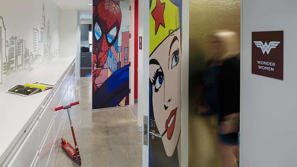 A hallway with a row of paintings.