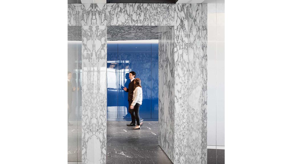 A man and woman kissing in a doorway.