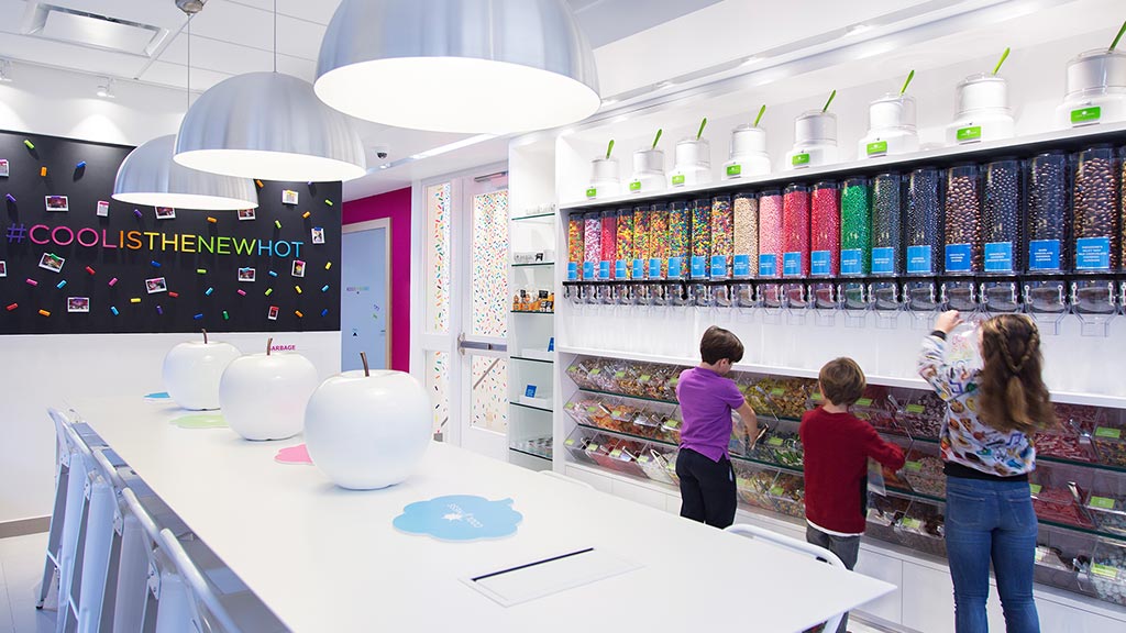 A group of people in a room with a large white table and white balls.