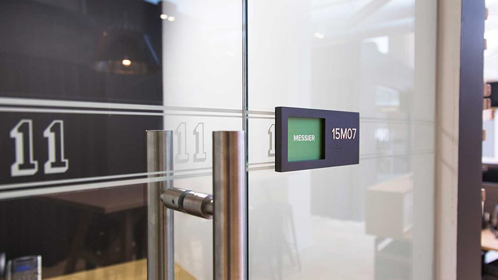 A glass door with a sign on it.