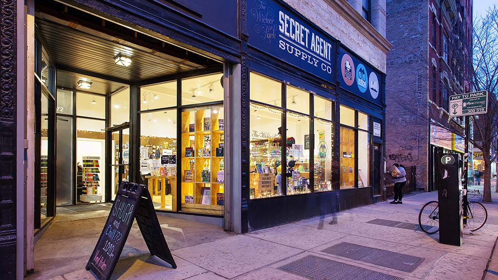 A store front with a sign in front.
