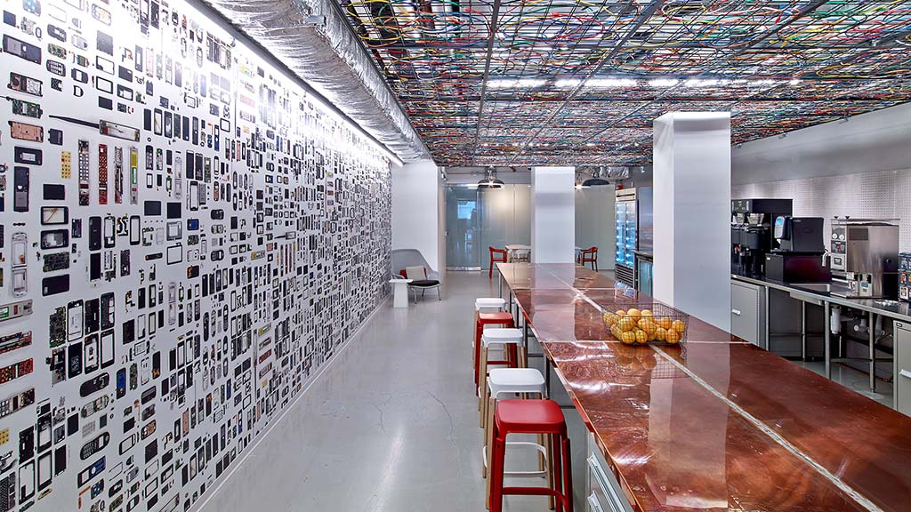 A room with a wall of pictures.