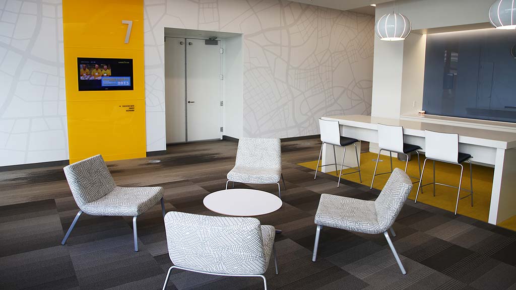 A room with a table chairs and a tv.