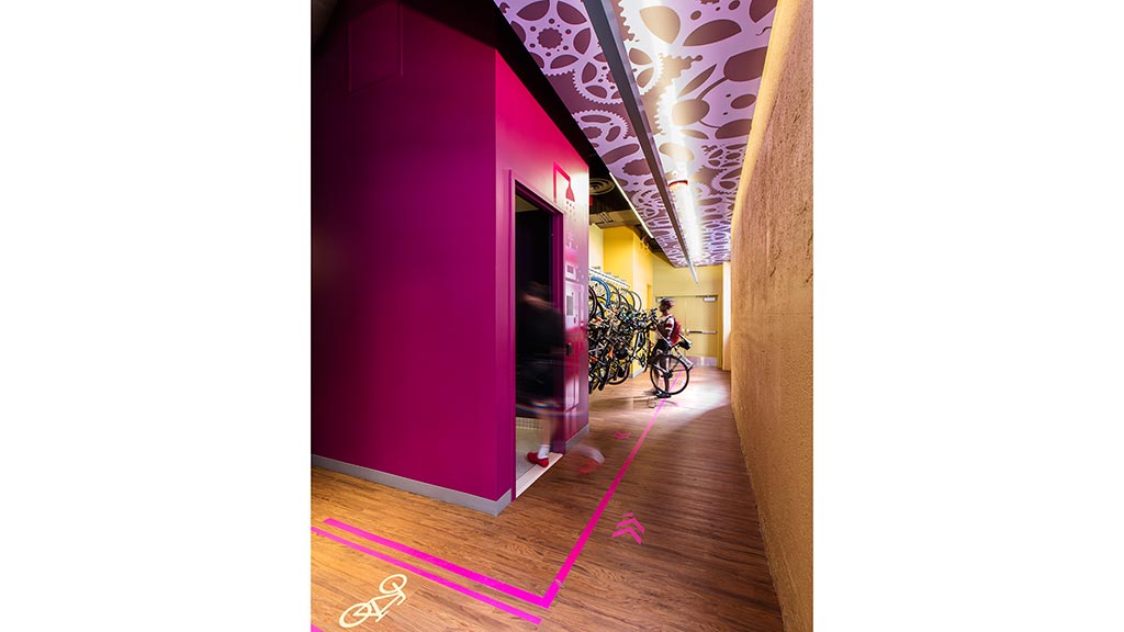 A person riding a bike through a doorway.