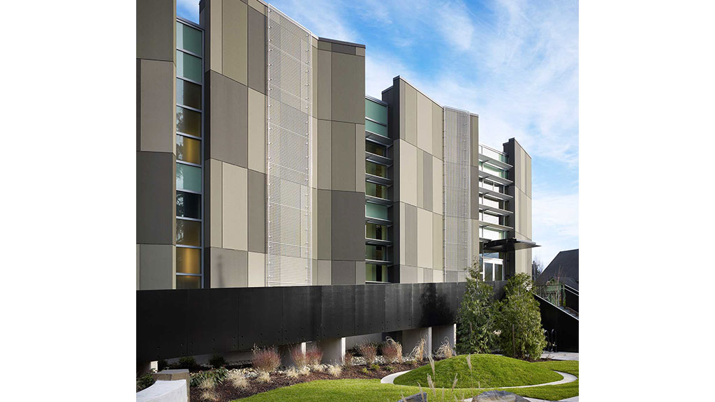 A building with a green lawn.