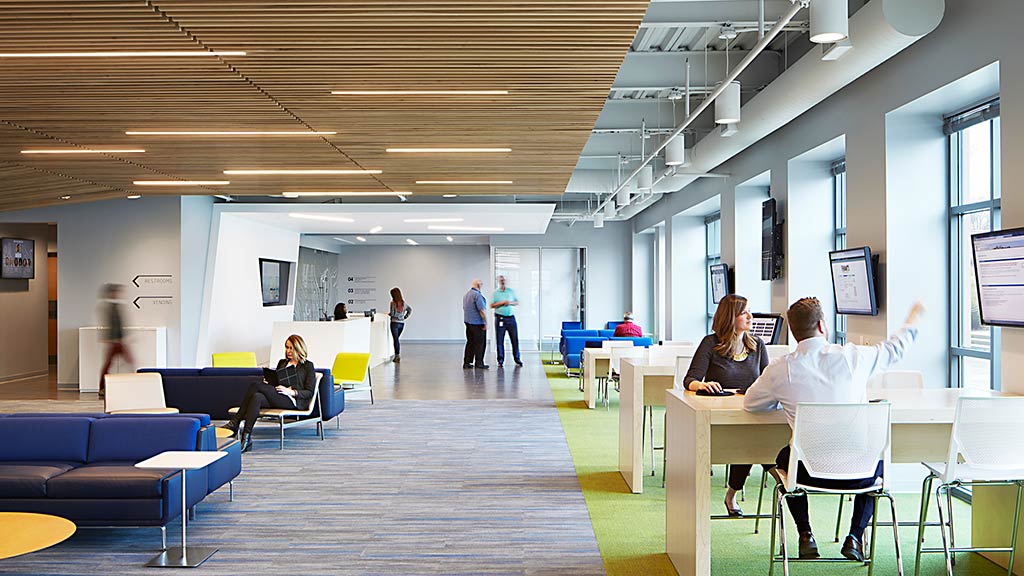 People in a room with tables and chairs.