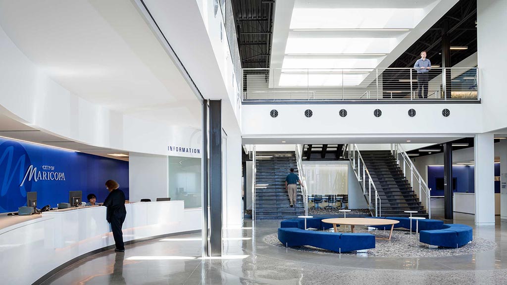 A few people walking inside a building.