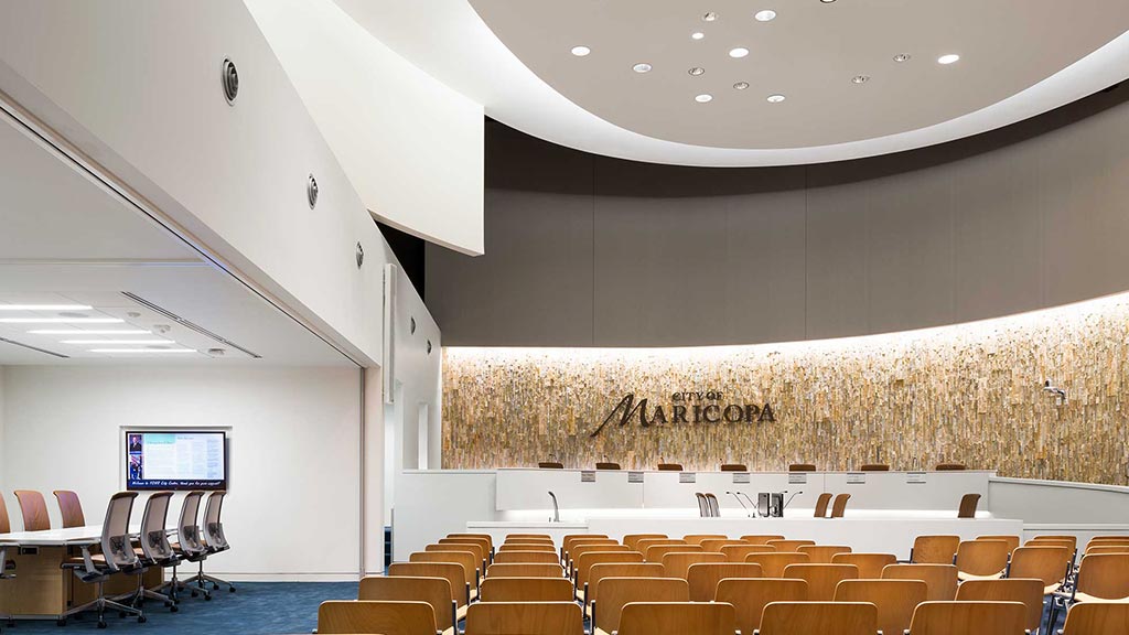 A room with a stage and chairs.