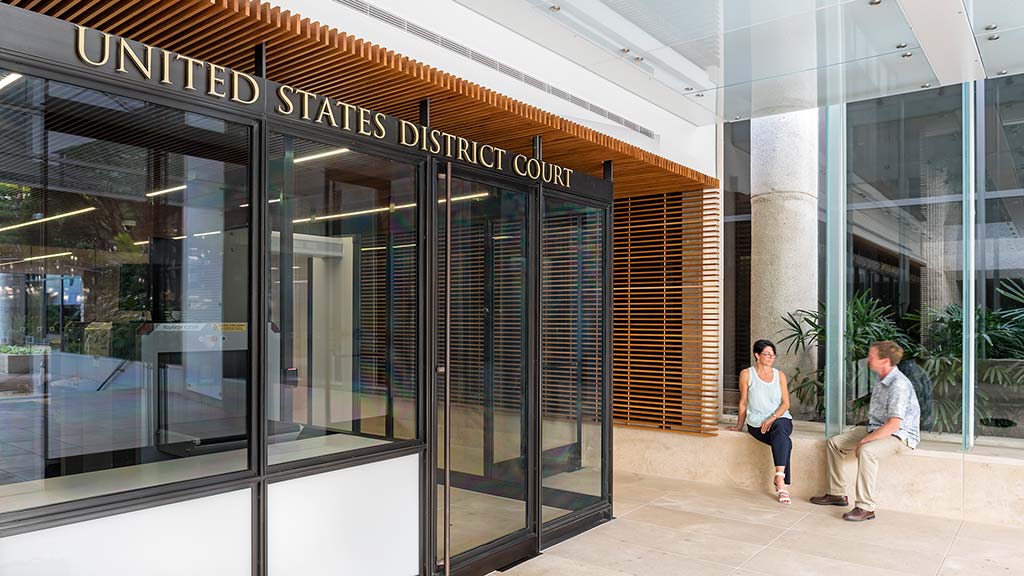 A man and woman sitting outside a building.