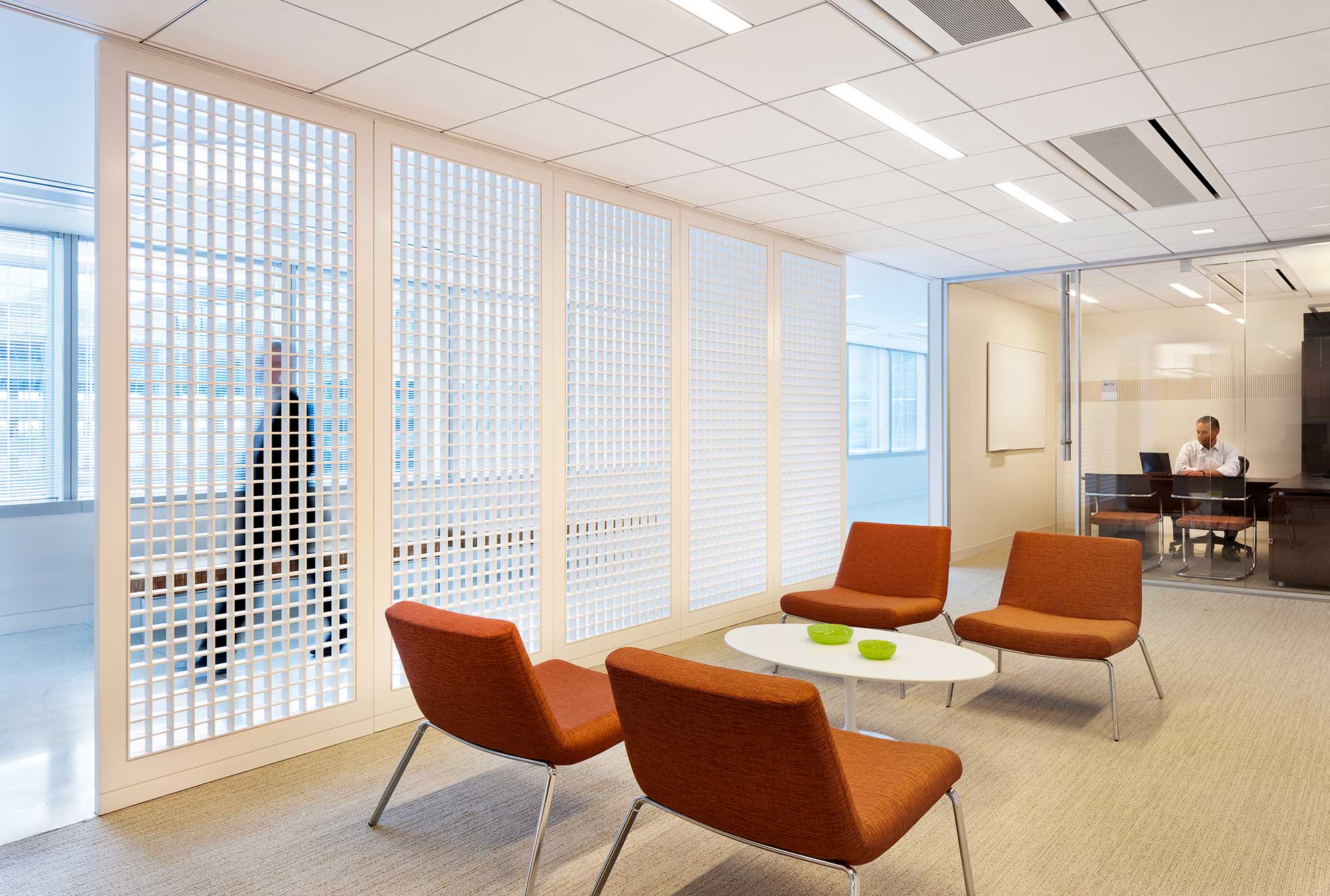 A room with a table chairs and a large window with large windows.